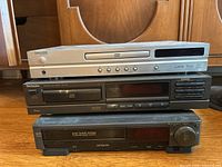Image showing stacked Koss DVD player on top, Technics SL-P170 CD player middle, Hitachi cassette player bottom.