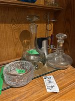 Image showing the textured glass candle holder, Riedel carafe, clear glass decanter, and metal candle holder stand on a glass shelf
