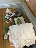 Overview of table accessories including linens, ceramic items, trivets, and decorative plate