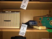 Four vintage radios on wooden shelf: two Sony AM/FM Nine Transistor radios (beige mesh grille), blue plastic radio, green vintage radio with gold grille.