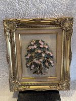 Full view of the framed artwork showing the ornate gold wooden frame and mounted 3D floral tree.