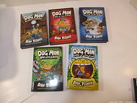 Five Dog Man hardcover books laid out showing front covers
