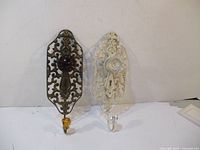 Two vintage door knob wall hooks displayed side by side against a white background, showing front view and details.