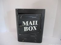 Front view of black metal mailbox key holder with 'MAIL BOX' text on door.