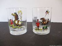Front view of two Norman Thelwell style illustrated glasses showing colorful pony and child scenes