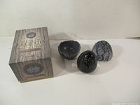 Full set showing egg, broken shell base, outer cracked shell, and box