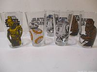 Front view of seven Star Wars character glasses showing C-3PO, BB-8, R2-D2, Chewbacca, and others.