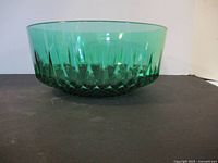 Side view of the green Arcoroc glass bowl showing vertical cut facets.
