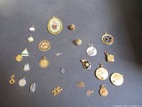 Overview of all 25 pendants and charms arranged on a dark background