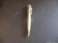 Full body view of the pencil-style lighter showing its pen-like shape and metal clip.