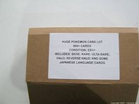 Printed lot label on cardboard box reading details of card count, condition, and inclusions