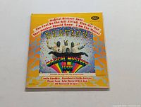 Front cover of Beatles Magical Mystery Tour album with colorful psychedelic art and band members' image