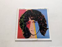 Front cover of the Billy Squier Emotions in Motion LP showing colorful stylized portrait artwork