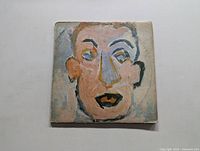 Front cover of the 'Self Portrait' album showing abstract painted face artwork.