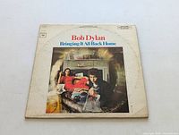 Front of the Bob Dylan Bringing It All Back Home LP album cover, showing Bob Dylan and a woman sitting in a room.