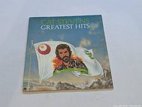 Front cover of Cat Stevens Greatest Hits LP showing illustrated portrait and flags