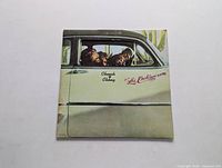 Front cover of Cheech & Chong Los Cochinos LP showing the duo inside a car.