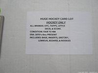 White paper label describing the hockey card lot with details on brands, eras, and players included