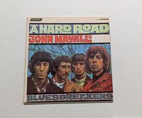 Front view of the album cover for John Mayall and the Bluesbreakers "A Hard Road" LP, showing the illustrated band portrait and title.
