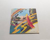 Front cover of the LP titled 'Thoughts of Movin On' by Lighthouse. Shows colorful artwork with flying red bird and surreal landscapes.