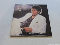 Front cover of Michael Jackson Thriller LP showing iconic cover photo of Michael Jackson in white suit jacket and black shirt.
