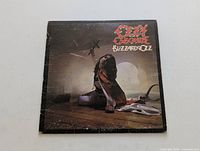 Front cover of Blizzard of Ozz vinyl LP by Ozzy Osbourne showing album title and artwork.