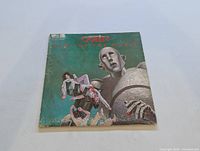 Front cover of the Queen 'News of the World' album showing illustrated art and wear on edges.