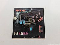 Front cover of REO Speedwagon Hi Infidelity vinyl LP record, showing artwork with man and woman silhouettes.