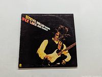 Front cover of Steve Miller Band Fly Like An Eagle vinyl LP showing Steve Miller playing guitar.