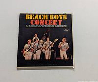 Front cover of The Beach Boys Concert vinyl LP showing band members on stage.