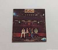 Front cover of The Guess Who Live at the Paramount LP showing band members in the venue.