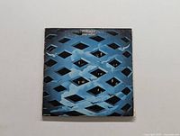 Front cover of The Who's Tommy album showing blue lattice design and eyes