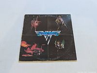 Front cover of Van Halen self-titled LP showing band members and Van Halen logo with visible wear and creasing on edges.