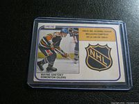 Front of the 1980/81 Wayne Gretzky O-Pee-Chee hockey card #384 showing image of Gretzky in Edmonton Oilers uniform with NHL logo and scoring leader title.