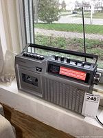 Front and side view of vintage Crosley radio showing cassette tape deck and control knobs.