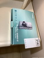 Original Canon PowerShot SD800 IS camera box shown closed with image of camera on front