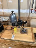 Full view of vintage Gamma II enlarger mounted on wood base with attached accessories, displayed on a workbench.