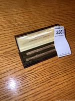 Wahl gold filled mechanical pencil and pen set in original black case with satin lining, showing interior and contents.