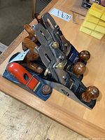 Photo showing the four different woodworking hand planes grouped together on a table.