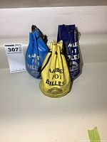 Three vintage drawstring bags in yellow, blue, and dark blue with label Marble 101 Billes from Andros brand.