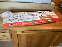 Photo of the box top showing model kit branding and depiction of the Skylane plane model with marketing text.