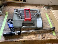 Mastercraft wrench set, torque wrench, Allen keys, and socket case on wood surface showing overall items in the lot with case and tools together.