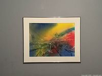 Front view of the framed abstract artwork showing vibrant colors and signature in lower left corner.