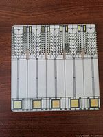 Full tile showing geometric "Tree of Life" design in muted earth tones and clean lines.