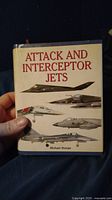 Front cover of 'Attack and Interceptor Jets' book showing title, author and jet illustrations.