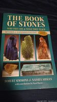 Front cover of The Book of Stones book showing various crystals and minerals on cover.