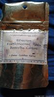 Sealed golden metallic pouch labeled 'Ethiopian Frankincense Resin Boswellia Carterii 1 Ounce Certified Kosher'
