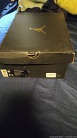 Closed black Jordan shoe box with gold Jumpman logo and size 9 US label
