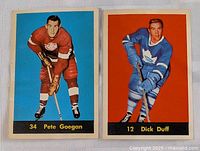 Two hockey cards side by side, Pete Goegan on blue background, Dick Duff on orange background