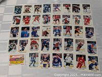 Photo showing 42 individual 1987-88 OPC Mini hockey cards laid out, featuring various star and rookie players in team uniforms.